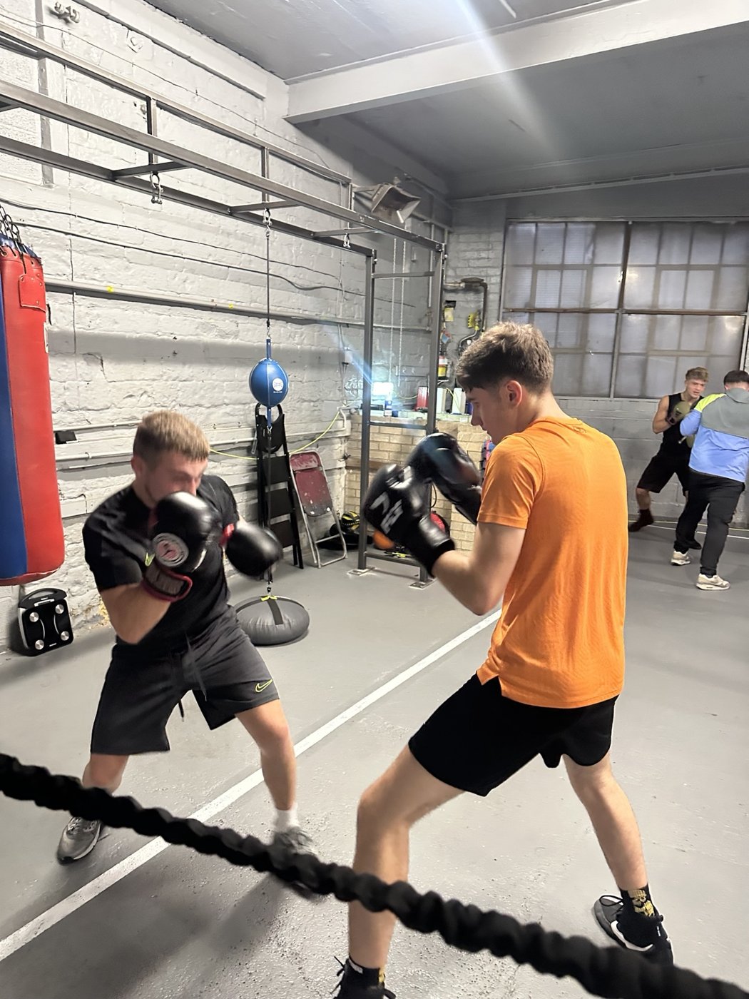 Boxers practising their technique with a partner
